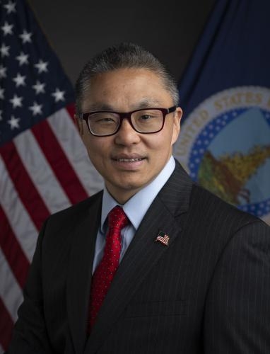 John Walk portrait with Americal flag and USDA logo in the background